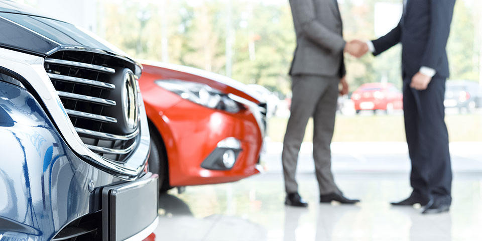 shaking hands over a deal about a new car