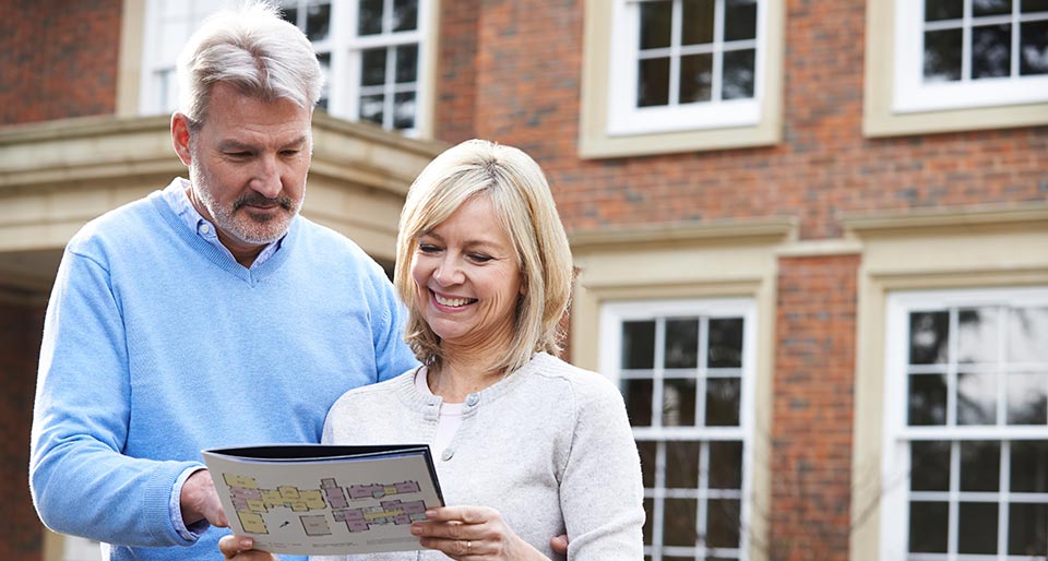 a couple looking at a brochure they received in the mail