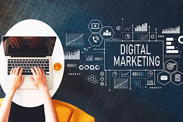 digital marketing message and symbols and someone typing on a laptop