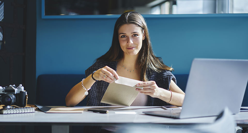 woman opening letter