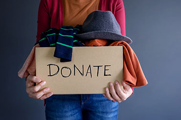 lady carrying a box of donations for a charity