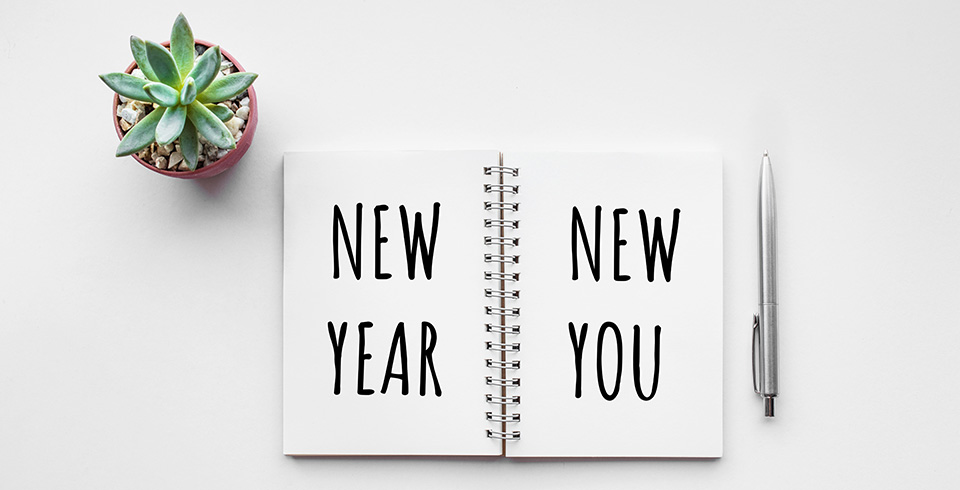new year new you message with a plant beside it