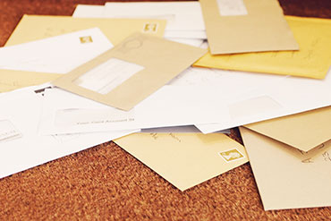 charity supporter opening mail at her desk