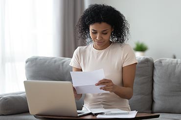 woman looking interested in opening her mail